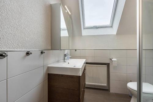 a bathroom with a sink and a toilet at Ferienhaus Rosswangen in Balingen