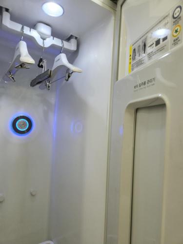 a bathroom with a mirror and lights on a train at The Mark Sokcho Residence Hotel #15F in Sokcho