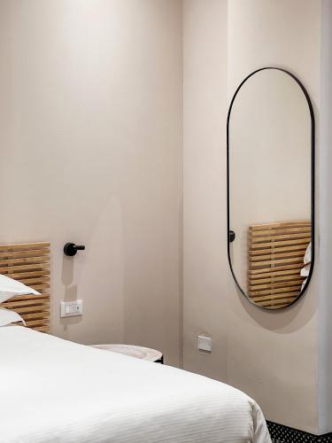 a bedroom with a mirror and a bed at Hotel Villa Rosa Riviera in Rimini