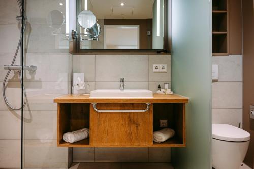 a bathroom with a sink and a shower at Hotel Restaurant Krone in Sulzbach am Kocher