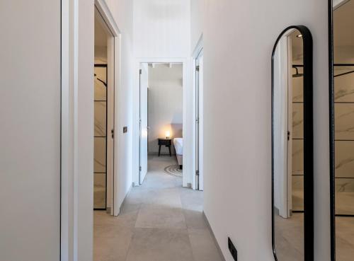 a hallway with a mirror and a bedroom at The Wave - Excellently located Penthouse with pool in Jan Thiel