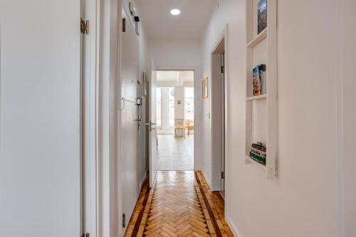 a hallway with white walls and a wooden floor at Belém River Apartment View in Lisbon