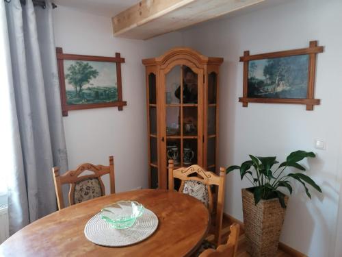 a dining room with a wooden table and chairs at Pension Am Buhnenkopf in Tangermünde