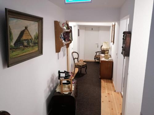 a hallway with a room with a painting on the wall at Pension Am Buhnenkopf in Tangermünde