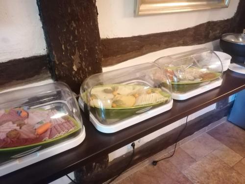 three trays of food sitting on a counter at Pension Am Buhnenkopf in Tangermünde