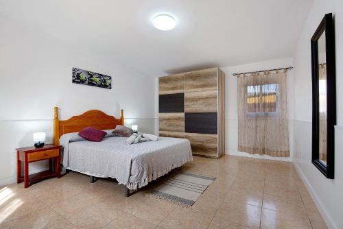 a bedroom with a bed and a table and a window at Casa Cactus in Antigua