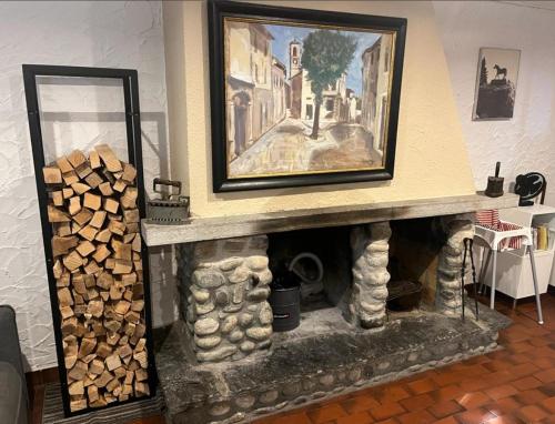 a fireplace with a picture on top of it at Casa Parentela in Ligornetto