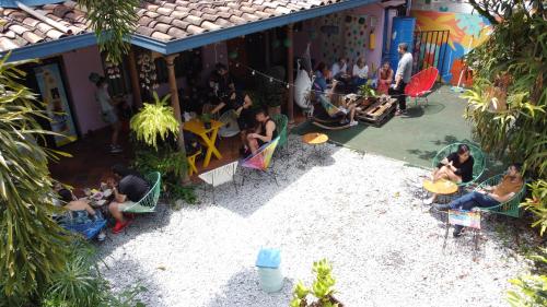 a group of people sitting outside of a building at Yolo Hostel Medellin in Medellín