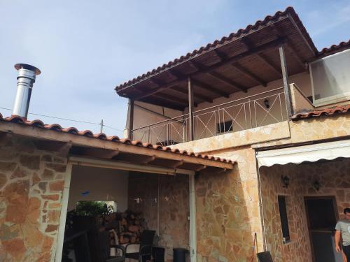 a building with a balcony on top of it at Marathon VS LUXURY VILLA in Grammatiko