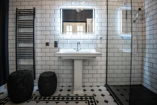 a bathroom with a sink and a mirror at Domus Balthasar Boutique Hotel in Prague
