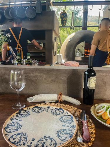 a bottle of wine and a plate of food on a table at Viscas Lodge in Carhuaz