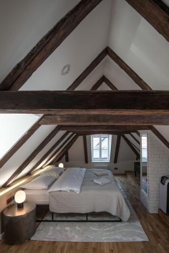 a bedroom with a large bed in the attic at Domus Balthasar Boutique Hotel in Prague
