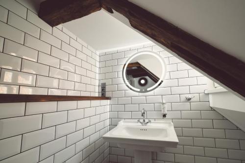 a bathroom with a sink and a mirror at Domus Balthasar Boutique Hotel in Prague