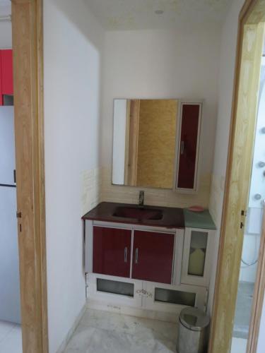 a bathroom with a sink and a mirror at Beautiful appartment with a glorious sea view in Monastir