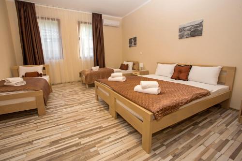 a hotel room with two beds in a room at Hotel Hana in Mostar