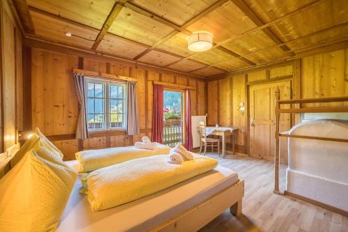 a bedroom with a bed with two cats laying on it at Ferienhaus Oberschneider in Selva dei Molini