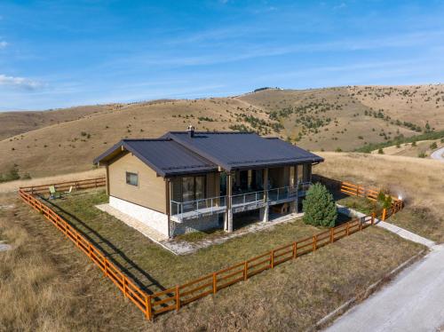 a house on a hill with a fence around it at Vila Cigota Zlatibor in Zlatibor