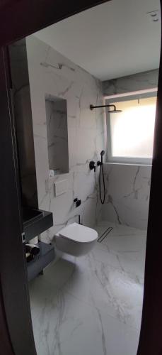 a white bathroom with a sink and a toilet at Studio Campului in Cluj-Napoca