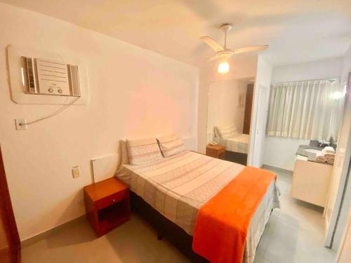 a bedroom with a bed and a ceiling fan at Ocean Flat 606 in Vila Velha