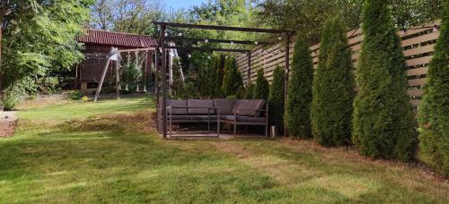 a chair sitting under a pergola in a yard at Studio Campului in Cluj-Napoca