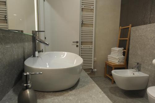 a bathroom with a tub and a toilet and a sink at Argo Apartments in Ljubljana