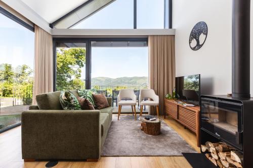 a living room with a couch and a television at Casas de Bouro 3 Casa do Alecrim in Terras de Bouro