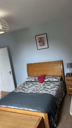 a bedroom with a bed with a wooden headboard at Goncalves place in Bournemouth