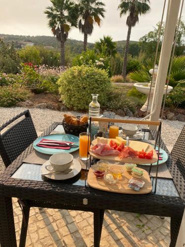 a table with a tray of food and orange juice at Quinta da Luz - A Luxury Boutique B&B in Silves