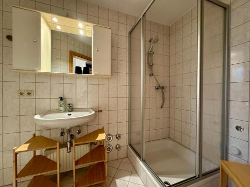 a bathroom with a sink and a shower at Charmantes Bauernchalet Alois in Dornbirn