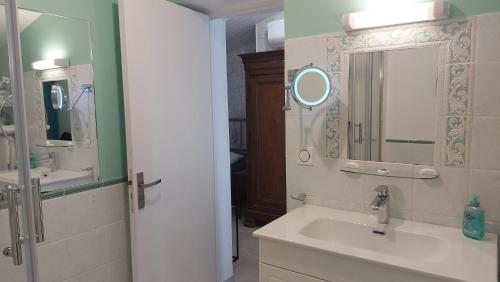 a bathroom with a sink and a mirror at MOULIN DE MAUZAC in Saint-Just