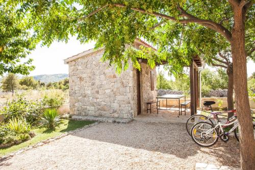 a bike parked in front of a stone house at Gabi Rooms & Studio Apartment in Lozovac