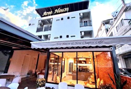 a store front of a building with a sign on it at Aree House Poshtel in Pattaya South