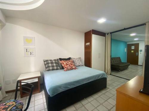 a bedroom with a bed and a living room at Pasargada 115 in Vila Velha