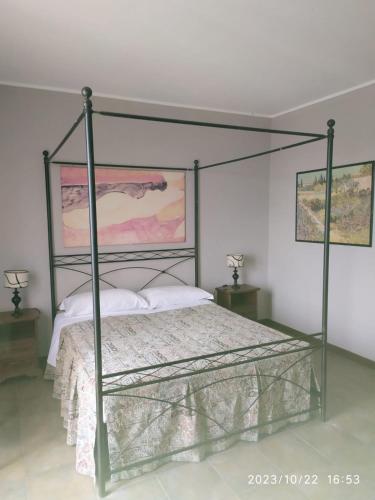 a bedroom with a bed with a metal frame at La Terrazza del Barbaresco in Neviglie