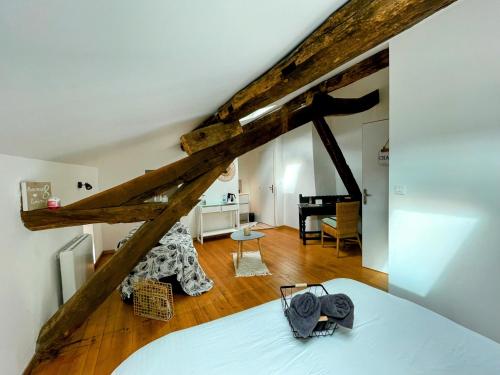 a bedroom with a bed and a room with a piano at Les Mirabelles in Tournon-dʼAgenais