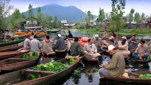 a group of people sitting in boats in the water at H.B Holiday home in Srinagar