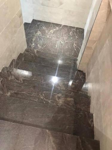 a staircase in a bathroom with a marble floor at Spacious studio apartment in a modern high-security building with lift access Includes free parking in Muyenga kampala in Kampala