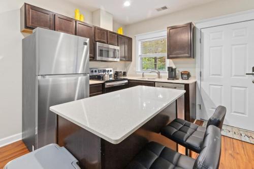 a kitchen with a white table and a refrigerator at Affordable 2-BR Heart of Detroit in Detroit