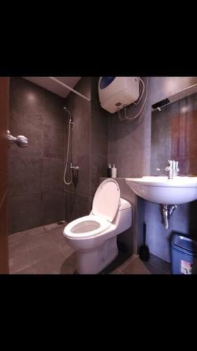 a bathroom with a toilet and a sink at Your Home in Bandung