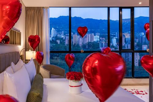 a room with a table with red heart balloons at Hotel York Luxury Suites Medellin by Preferred in Medellín
