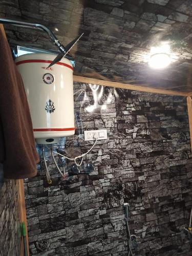 a drum on a wall in a room with a stone wall at H.B Holiday home in Srinagar