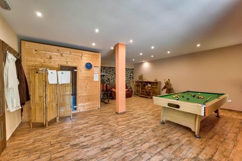 a large room with a pool table in a room at Mountain house Rupicapra with Sauna and Outdoor Hot Tub in Kostel