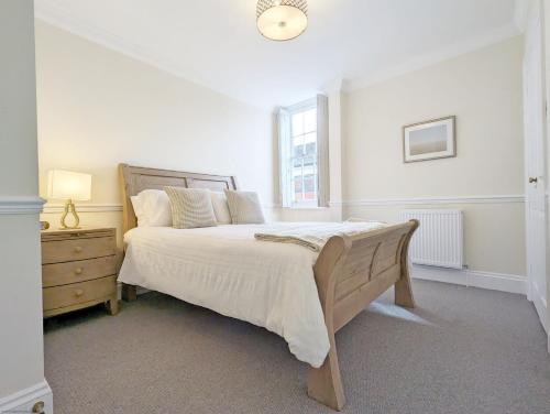 a bedroom with a large bed and a window at 5 The Clock House in Midhurst