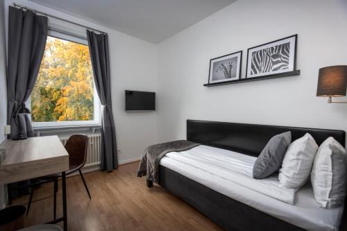 a bedroom with a bed and a window at Hotell Skövde in Skövde