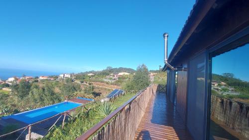 a view from the balcony of a house with a swimming pool at Casa Pereirinha in Estreito da Calheta