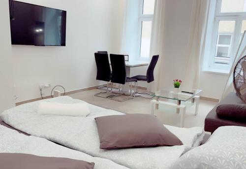 um quarto com duas camas e uma mesa e cadeiras em Queen Apartment 4P WL em Viena
