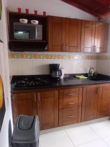 a small kitchen with a stove and a microwave at Casa b in Itagüí
