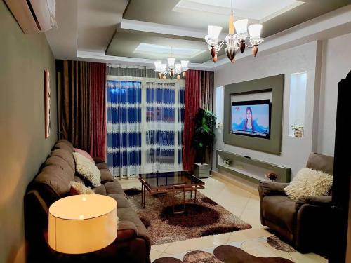 a living room with a couch and a tv at Sharm Hills Hotel in Sharm El Sheikh