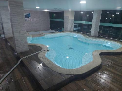 a large swimming pool in the middle of a building at 109-Alquiler Deptos Complejo SummerBeach Bombinhas in Bombinhas