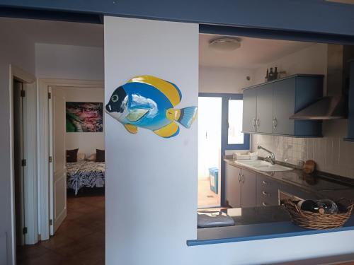 a view of a kitchen with a fish on the wall at Casa de Famara in Famara